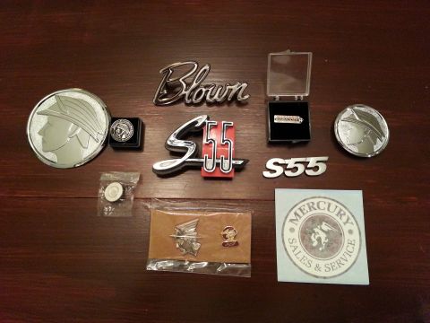 2003 Mercury Marauder - Collection of Mercury emblems and memorabilia, including a 'Blown' script, 'S55' badges, and a 'Mercury Sales & Service' sticker.