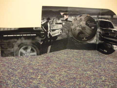 2003 Mercury Marauder - Promotional booklet for a 2003 Mercury Marauder DVD, images of the car and text about tuning up a DVD player.