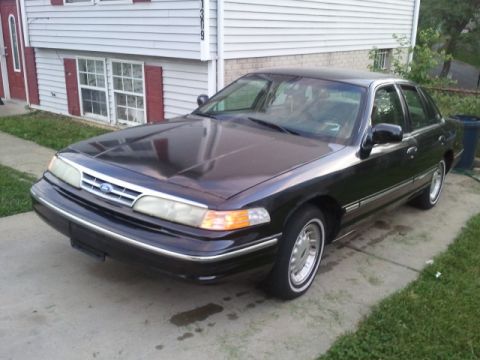 1997 Ford Crown Victoria - 1997 Ford Crown Victoria sedan parked on a concrete driveway.