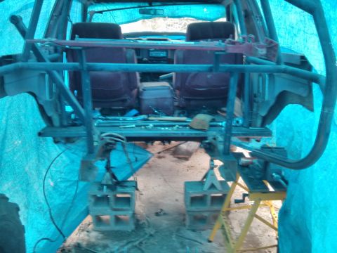 1986 Ford Bronco - This SUV is being worked on, with a roll cage installed and the vehicle supported by cinder blocks and jack stands.