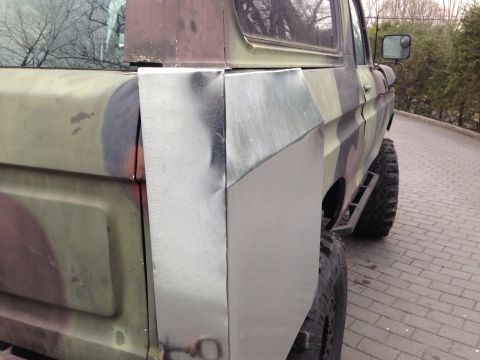 1979 Ford Bronco - This SUV features a camouflage paint scheme and custom metalwork on its rear quarter panel, obscuring its original year and model.