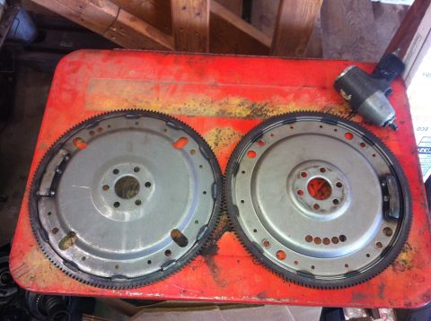 1982 Ford Bronco - Two flywheel assemblies are shown on a red surface, with an impact wrench nearby.