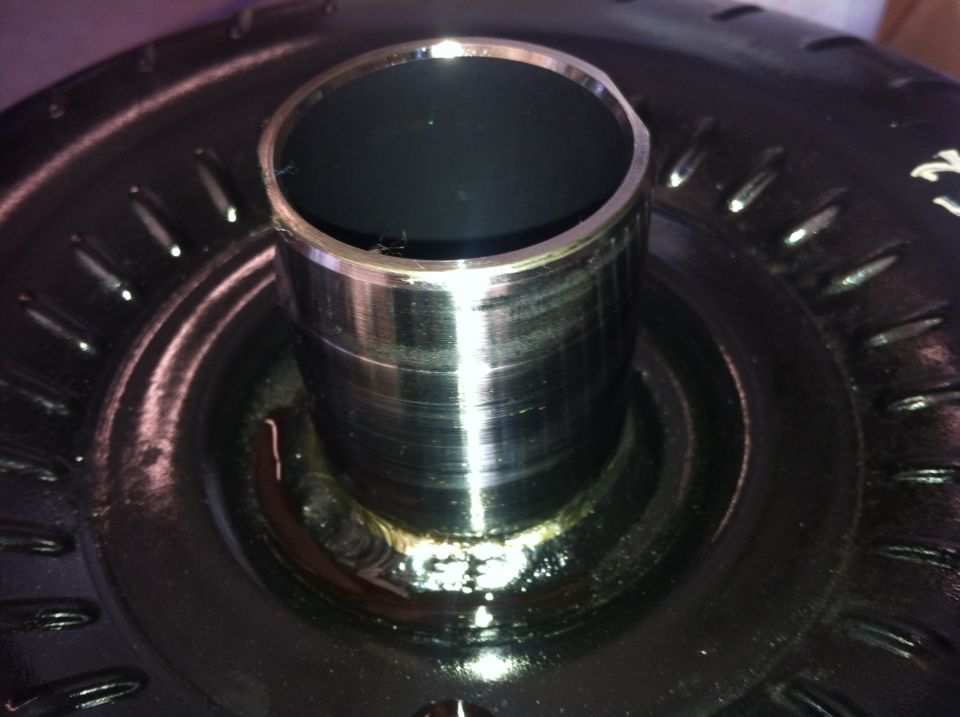 Close-up of a metal torque converter with a cylindrical input shaft
