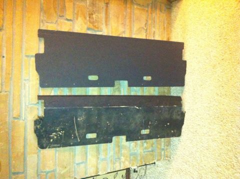 1982 Ford Bronco - Two black metal plates with cutouts are mounted on a brick wall. The Supermotors.net logo is visible.