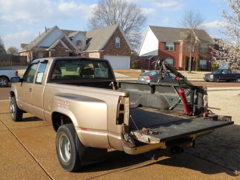 1997 Chevrolet Silverado 3500 - I lowered the crane until I could pick the camper up on my shoulders, and walked it to the back yard.