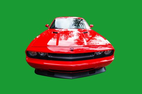 2010 Dodge Challenger - A red 2010 Dodge Challenger is shown from the front against a green background.