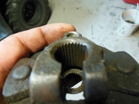 1979 Ford Ranchero - A greasy hand holds a steering shaft coupler/slip yoke up to the camera, showing the internal female splines and the empty pinch-bolt bore…