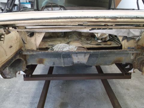 1964 Ford Galaxie - The rear frame and interior of a 1964 Ford Galaxie are visible, showing the car's undercarriage and exposed components.