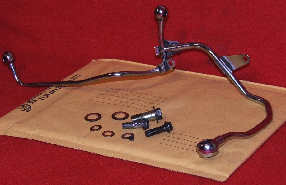 Motorcycle kickstand assembly with bolts and washers on a padded envelope