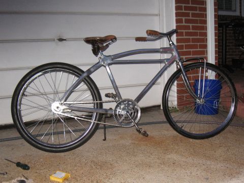 Custom bicycle with chrome frame, leather saddle, and wide tires