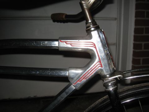 Chrome bicycle frame with red pinstriping and a brown handlebar grip