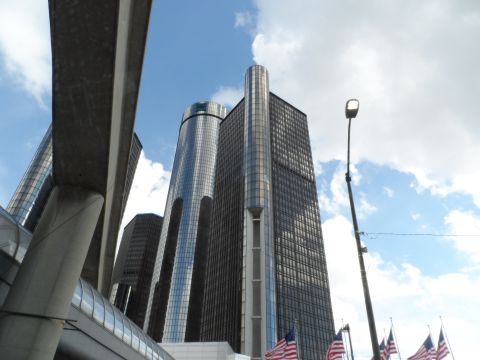 1971 Ford Ranchero - The iconic GM Renaissance Center dominates the Detroit skyline under a partly cloudy sky.
