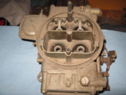 1963 Ford Galaxie - This carburetor, identified as a part for sale, has visible text indicating 'SUPERMOTORS' and its website.