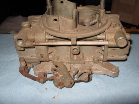 1963 Ford Galaxie - Carburetor part shown on a blue cloth surface.