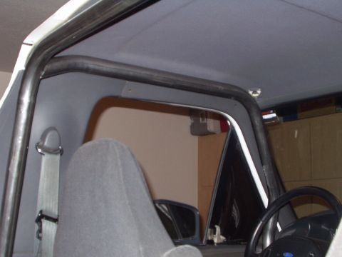 1993 Ford Bronco - Interior view of a vehicle's roll cage, with a seatbelt visible.