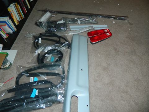 1979 Ford Bronco - Collection of new parts for a 1979 Ford Bronco, including taillights and various trim components.