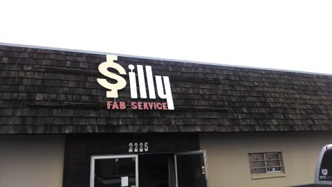 1985 Jeep CJ7 - Exterior view of Silly Fab Service, identified by its prominent signage and street number 2225.