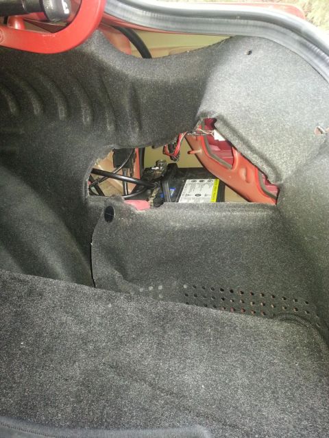 2010 Hyundai Genesis - The battery is located in the trunk of the vehicle, with visible text on its label.
