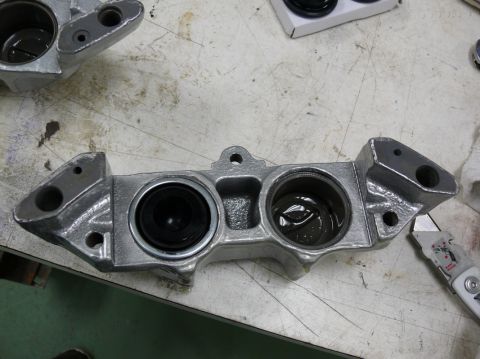 Close-up of a disassembled brake caliper with two pistons visible
