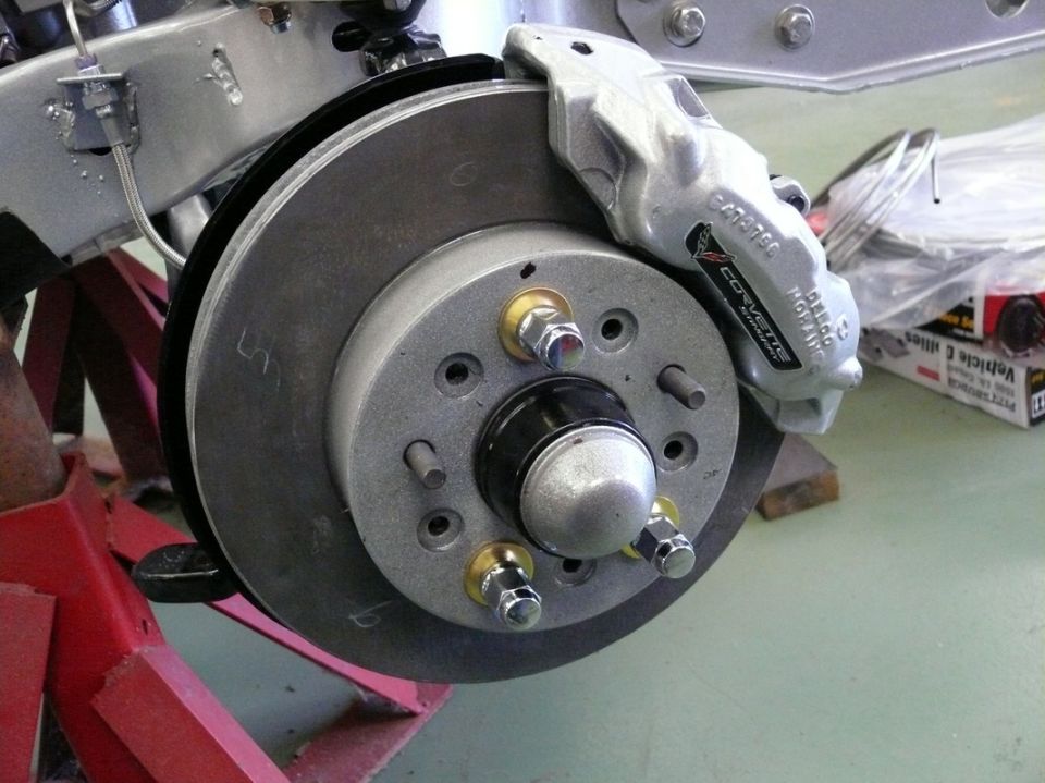 Silver Corvette brake caliper with 'CORVETTE' text, attached to rotor