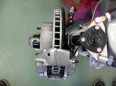 Car brake caliper and rotor assembly, close-up, overhead view