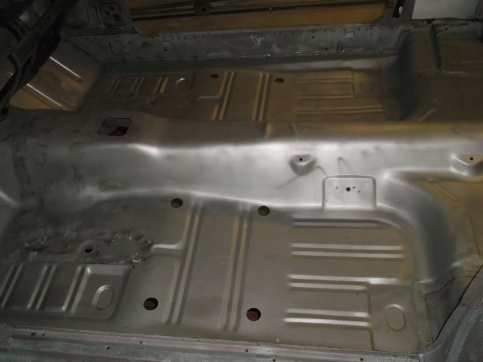 Bare metal floor pan of a classic car interior