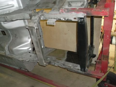 1967 Ford Mustang - The underside of a car frame is shown, undergoing restoration or repair work.