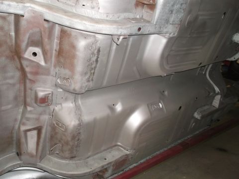 1967 Ford Mustang - Undercarriage view of a vehicle, focusing on the floor pan and structural components.