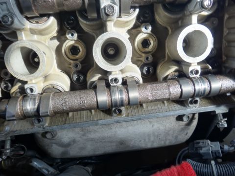 1993 Ford Taurus - Close-up view of an engine's camshaft, showing mechanical components and some visible text.