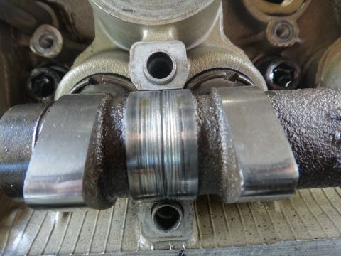 1993 Ford Taurus - This image shows a close-up view of a vehicle's engine camshaft, highlighting wear on its surface.