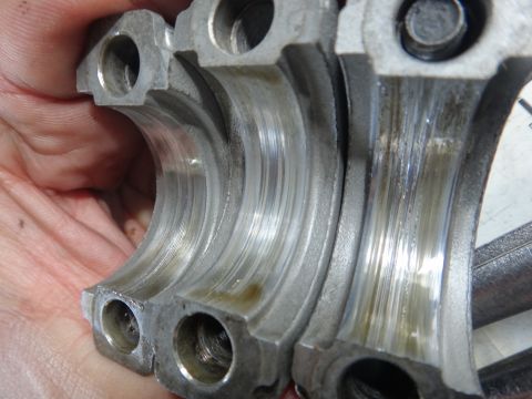 1993 Ford Taurus - Close-up view of engine bearing caps showing signs of wear and oil contamination.