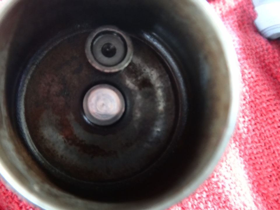 Close-up of two valve seats within a metal housing, likely a cylinder head