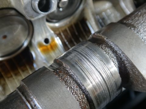 1993 Ford Taurus - This close-up shows significant wear and damage on a camshaft, indicating potential engine issues.