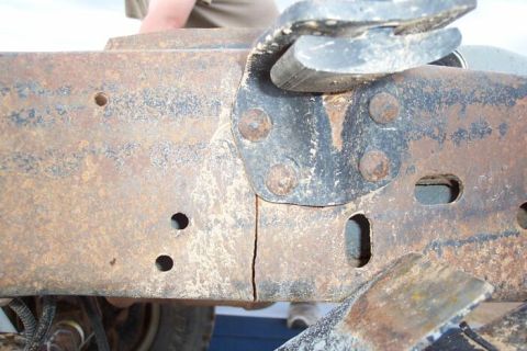 1990 Ford Bronco - Rusted vehicle frame shows a significant crack near a mounting bracket.