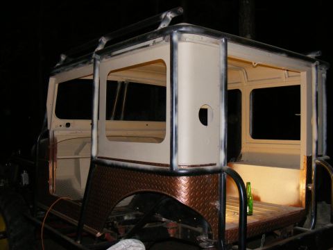 Off-road vehicle body with roll cage, diamond plate fender, and custom roof rack. Looks like a project in prog