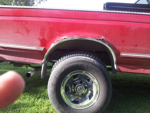 1995 Ford F-150 - This 1995 Ford F-150 shows rust around the rear wheel well, a common issue for trucks of this era.
