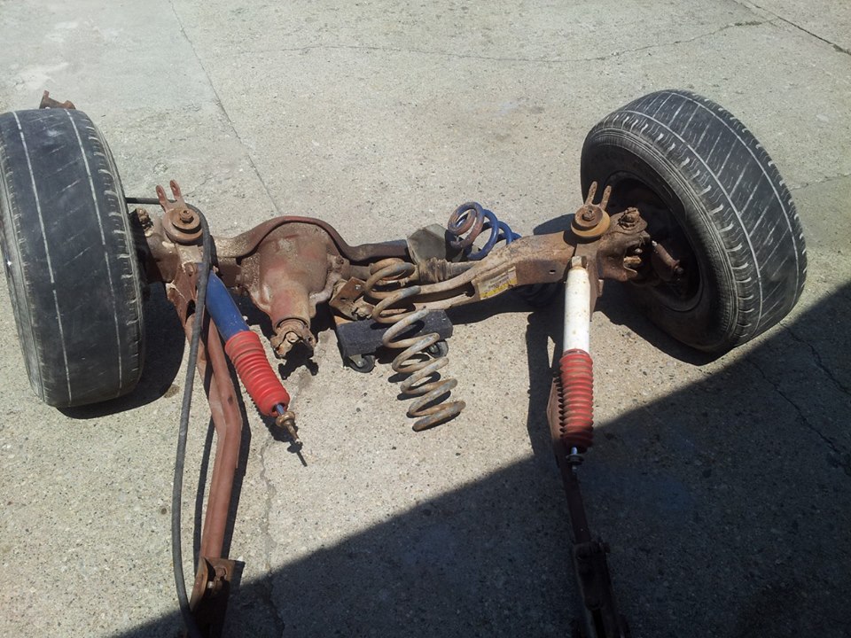 Rear axle assembly with two wheels, springs, and shocks