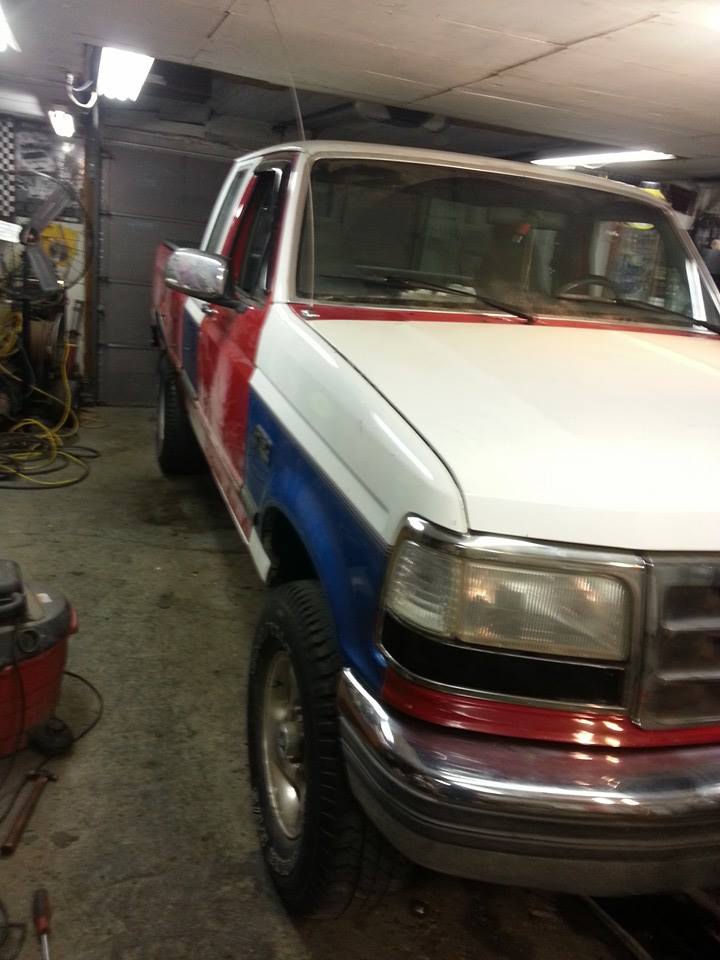 Red, white, and blue 1995 Ford F-150 pickup truck, 3q-front view