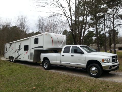 1967 Ford Mustang - White 2003 Dodge Ram 3500 dually truck is seen towing a large white fifth-wheel recreational vehicle.