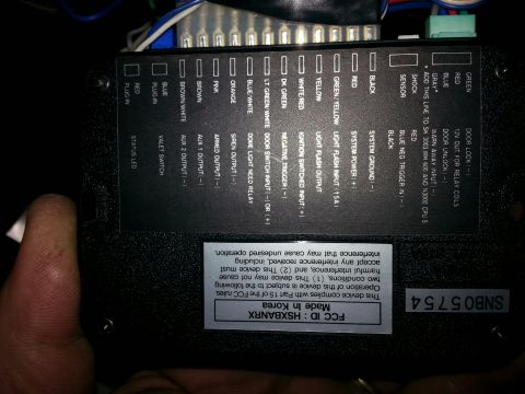 2007 Dodge Durango - Close-up of an electronic control module, showing labeled wire inputs and FCC compliance information.