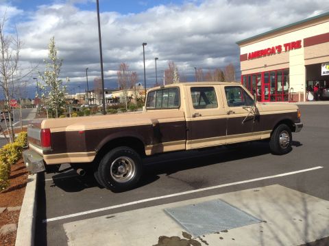 1988 Ford F-350 - This Ford F-350 Crew Cab Dually pickup truck is parked outside an America's Tire store.