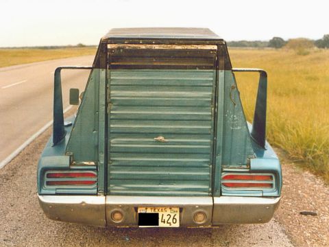 1972 Ford Ranchero - This heavily modified pickup truck features a unique rear end with a roll-up door and prominent fins.