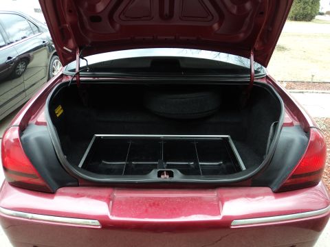 2004 Mercury Grand Marquis - Trunk interior of a 2004 Mercury Grand Marquis, with spare tire and organizer tray visible.
