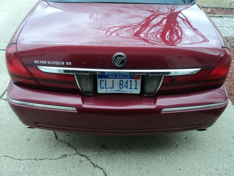 2004 Mercury Grand Marquis - Rear view of a red Mercury Grand Marquis GS showing the trunk lid and license plate.
