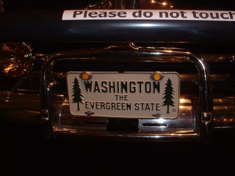 1999 Ford Crown Victoria - Rear view of a vehicle showing a Washington license plate and a warning sticker.