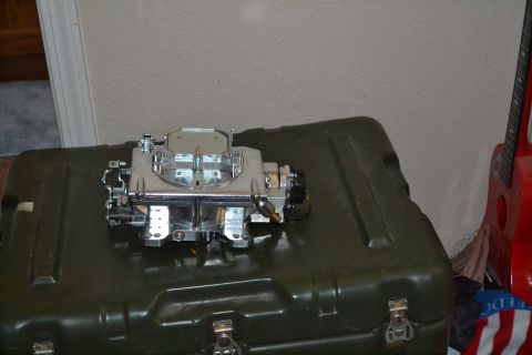 1981 Ford F-250 - A carburetor is pictured on top of a large case, with part of a guitar in the background.
