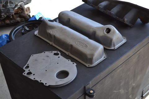 1981 Ford F-250 - Engine parts including valve covers and timing cover are laid out on a surface.