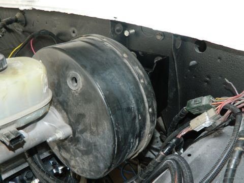 1979 Ford Bronco - Close-up view of the brake booster and master cylinder assembly, likely from an older vehicle's engine compartment.