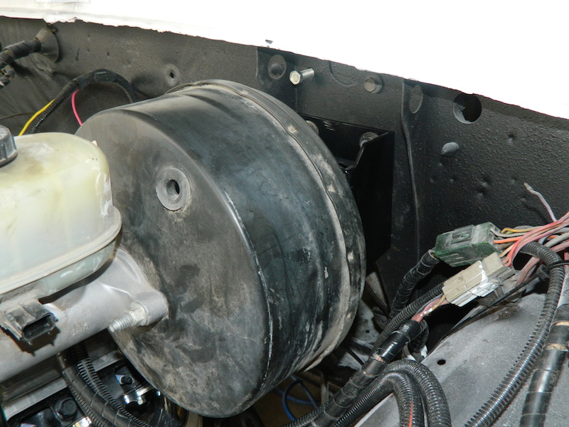 Brake booster and master cylinder assembly in engine bay