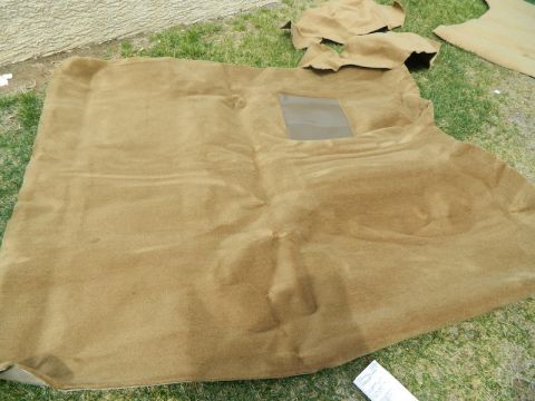 1979 Ford Bronco - Carpet pieces laid out on the grass, possibly for replacement or cleaning.
